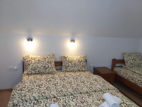 a bedroom with a bed with two pillows at Domaćinstvo Krstajić - Rural holiday in Žabljak