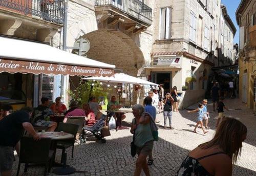 a group of people walking around in a street at B&B Champdelaplume in Barjac