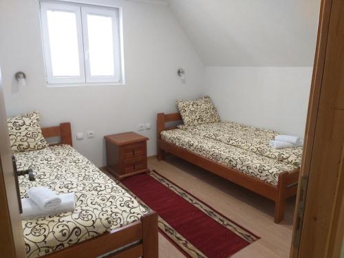 a small room with two beds and a window at Domaćinstvo Krstajić - Rural holiday in Žabljak
