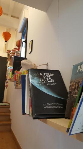 a book hanging on a wall with books at Villa Chamarel in Carcès