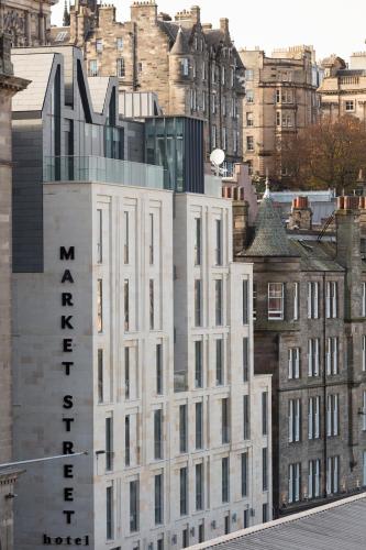 a white building with a sign on the side of it at Market Street hotel in Edinburgh