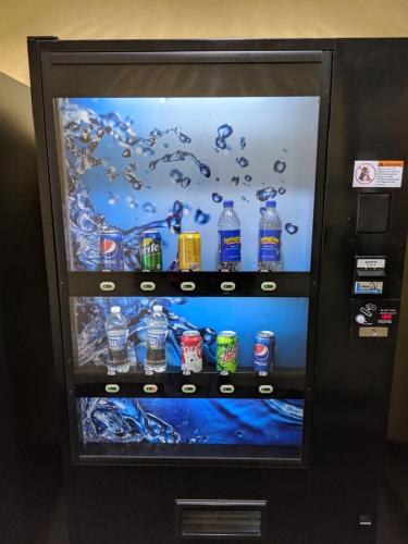 a vending machine filled with bottles of soda at Deluxe Inn - Fayetteville I-95 in Fayetteville