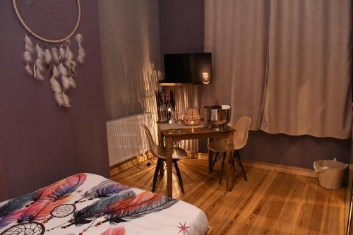 a bedroom with a desk and a table and a bed at Vip room 209 in Trooz