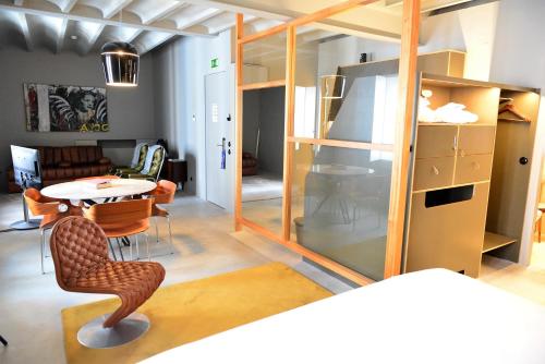 a room with a table and chairs and a mirror at Raw Culture Art & Lofts Bairro Alto in Lisbon