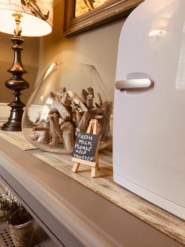 a shelf with a glass bowl filled with fish at The Bridge House in Bridport