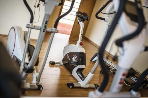 a room with several exercise machines on the floor at Biały Dom Henlex Hotel Restauracja in Poznań