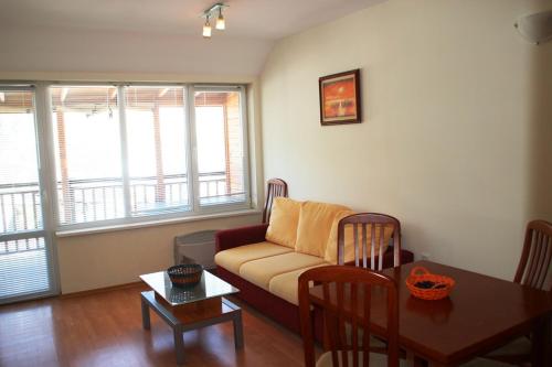 a living room with a couch and a table at Eagle Rock View Apartment, Borovets in Beli Iskar