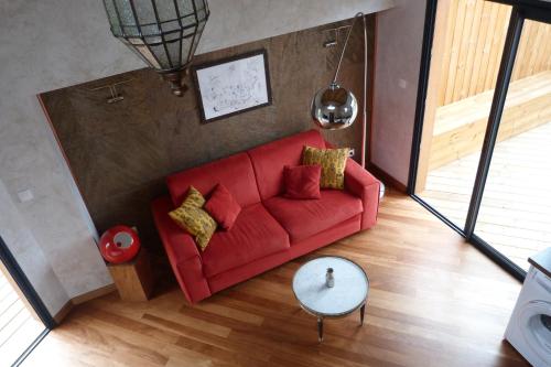 an overhead view of a living room with a red couch at L'Orée du Maïdo in Le Guillaume