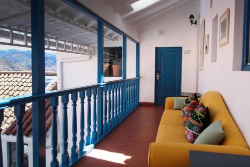 a living room filled with furniture and a blue couch at Tariq Boutique in Cusco