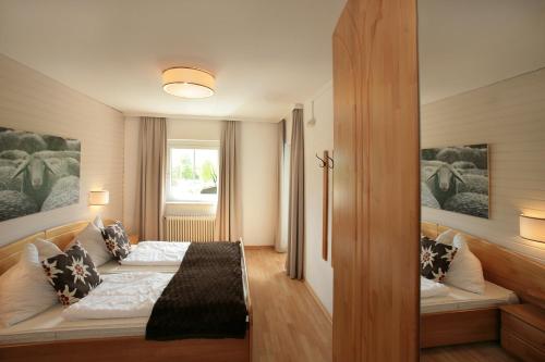 a bedroom with two beds and a window at Edelweiss am See in Zell am See