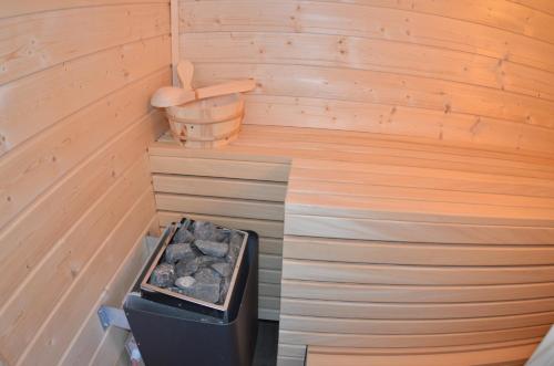 an inside of a sauna with a trash can at Traumhaus Ostwind- Rügen in Vieregge