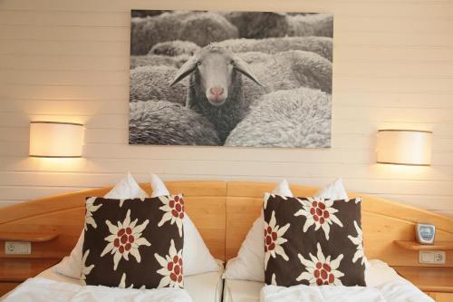 a bedroom with a bed with a picture of sheep at Edelweiss am See in Zell am See
