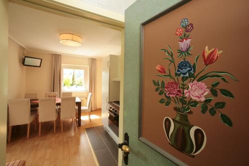 a room with a vase with flowers on the wall at Edelweiss am See in Zell am See