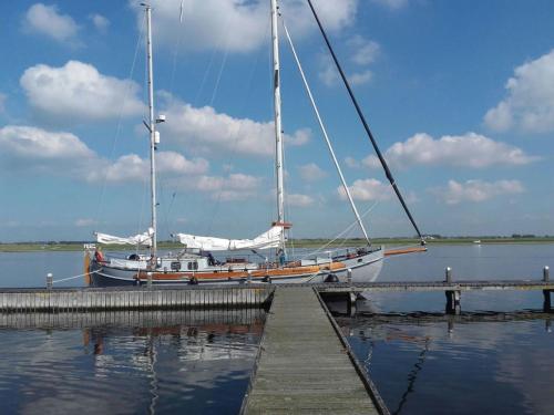 a sailboat is docked at a dock at Privé B&B Zeilboot Noorderlicht in Kamperland