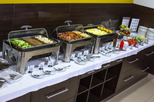 a buffet line with many different types of food at Optima Cherkasy Hotel in Cherkasy