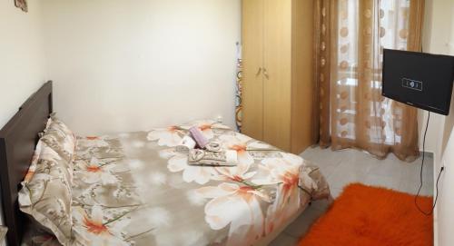 a bedroom with a bed with flowers on it at Kosta's Apartment 1 in Thessaloniki