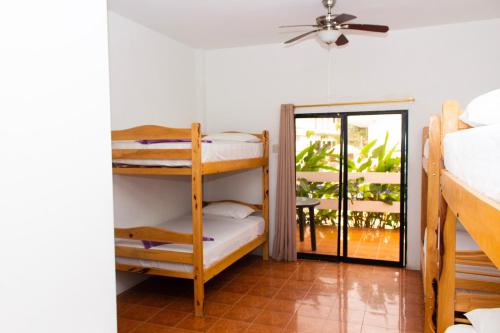 a room with two bunk beds and a patio at Hostería "El Paraíso" in Montañita