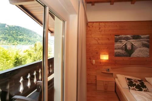 a room with a tub and a window with a view at Edelweiss am See in Zell am See