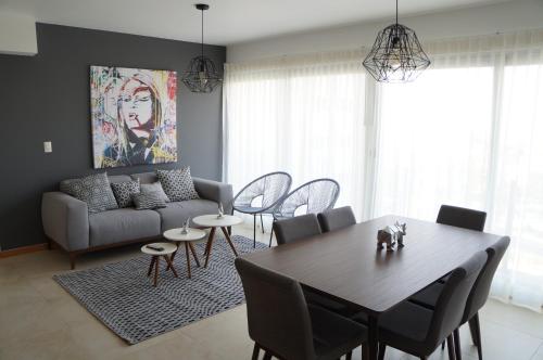 a living room with a table and a couch at Metropolitan Suites in Guadalajara