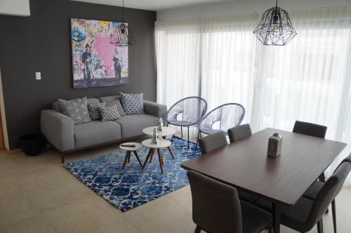 a living room with a table and a couch at Metropolitan Suites in Guadalajara
