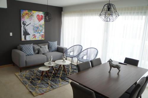 a living room with a table and a couch at Metropolitan Suites in Guadalajara