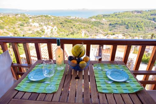 a wooden table with a bowl of fruit on it at Asteri Apartments in Alonnisos Old Town