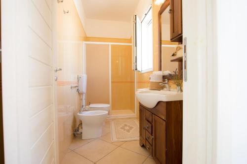 a bathroom with a toilet and a sink at Le Gioie - Villa Macchia Mediterranea - Splendida villa vista mare immersa nel verde in Torre Pali 