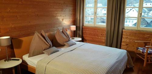 a bedroom with a large bed in a room with windows at Gästehaus Grogger in Weyer Markt