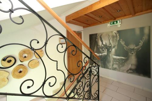 a staircase with donuts and deer paintings on the wall at Edelweiss am See in Zell am See