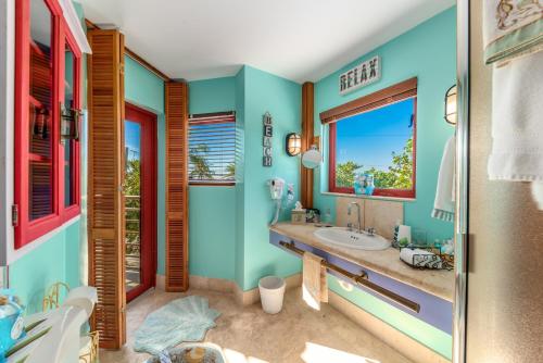 a bathroom with a sink and a window at Art on the Beach in Stuart