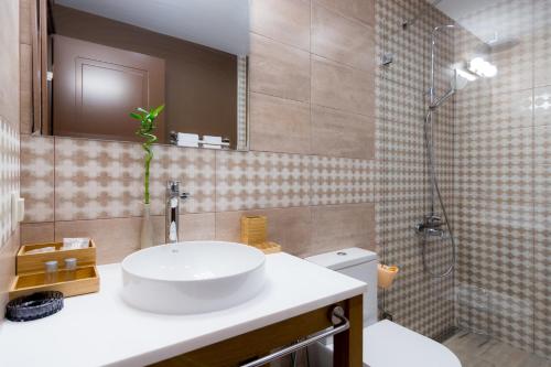 a bathroom with a sink and a shower at Luxury Chalet & Spa Tia Maria in Bansko
