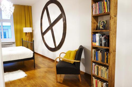 um quarto com uma cama e uma estante de livros com livros em Apartament Skorpion Centrum em Sanok