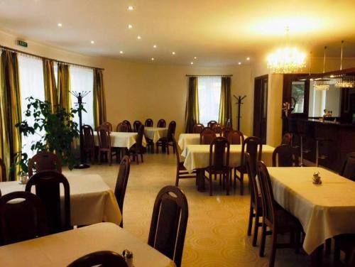 a dining room with white tables and chairs and tablesearcher at PENZION ANIKO GOLD *** in Horné Saliby