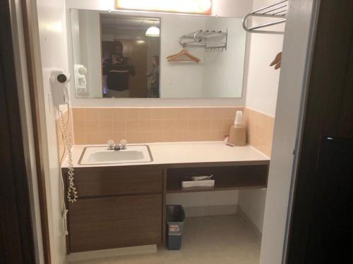 a bathroom with a sink and a mirror at Campbell Lodge in Glasgow