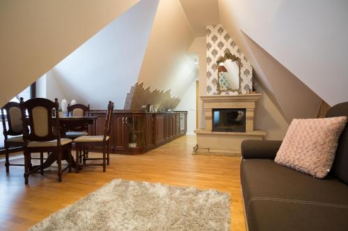 a living room with a couch and a fireplace at Apartamenty Ciche Wzgórze Zakopane in Zakopane