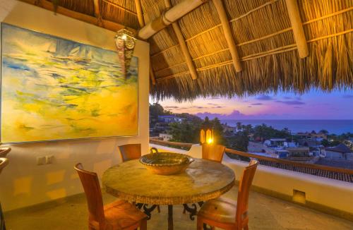 a dining room with a table and a view of the ocean at Mi Otra Casa in Sayulita