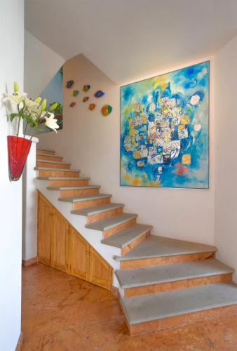 a staircase in a room with a painting on the wall at Mi Otra Casa in Sayulita