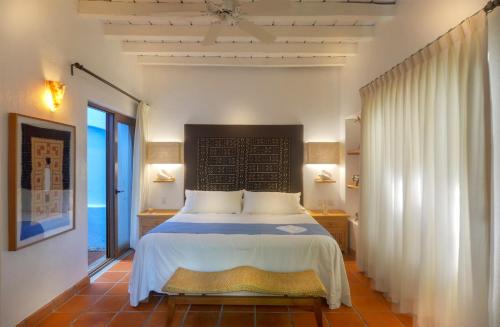 a bedroom with a large bed in a room at Mi Otra Casa in Sayulita