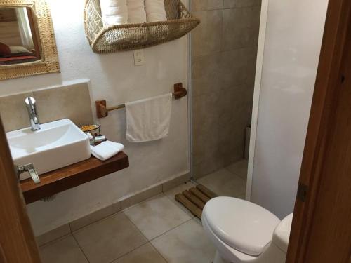 a bathroom with a sink and a toilet at Reserva Azul in Cuetzalán del Progreso