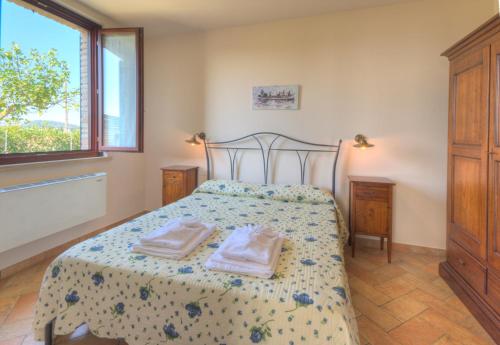 a bedroom with a bed with two towels on it at Casale del Conero in Porto Recanati