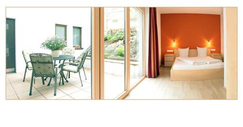 a hotel room with a bed and a table and a balcony at Bergkristall in Brand