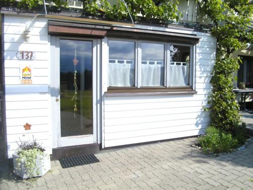 a white building with a window and a door at Ferienwohnung Lerch in Bregenz