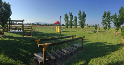 a park with a bench and a playground at Casale del Conero in Porto Recanati