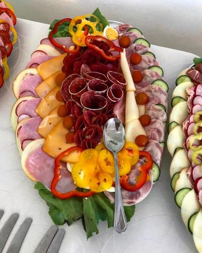 a platter of different types of food with a spoon at PENZION ANIKO GOLD *** in Horné Saliby