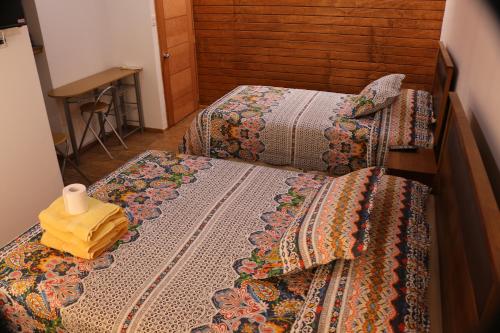 two beds in a room with two beds sidx sidx sidx at Hostal Luna del Mar 840-B in La Serena