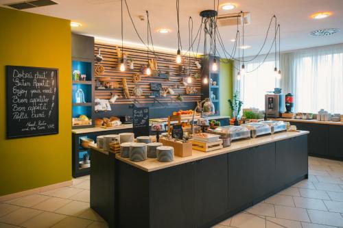 a bakery with a counter with food on it at Vienna House Easy by Wyndham Bratislava in Bratislava