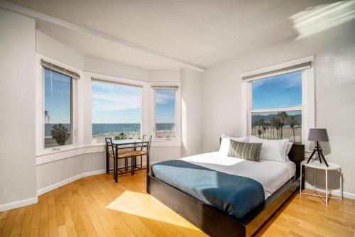 a bedroom with a bed with a view of the ocean at AIR Venice on the Beach in Los Angeles