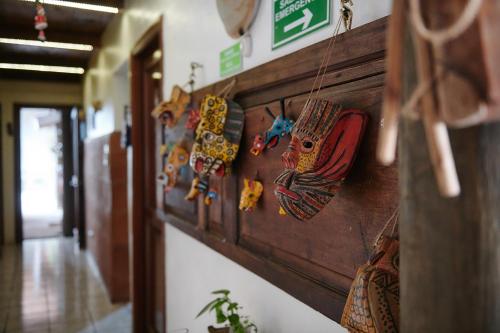 a wall with a bunch of cuckoo clocks on it at Dai Nonni Hotel in Guatemala