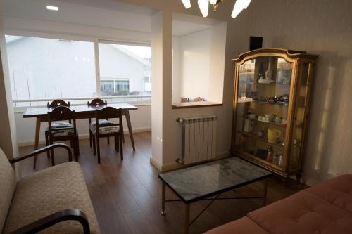 a living room with a table and a dining room at 70s House by Capicua in Braga