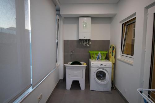 a laundry room with a washing machine and a sink at 70s House by Capicua in Braga